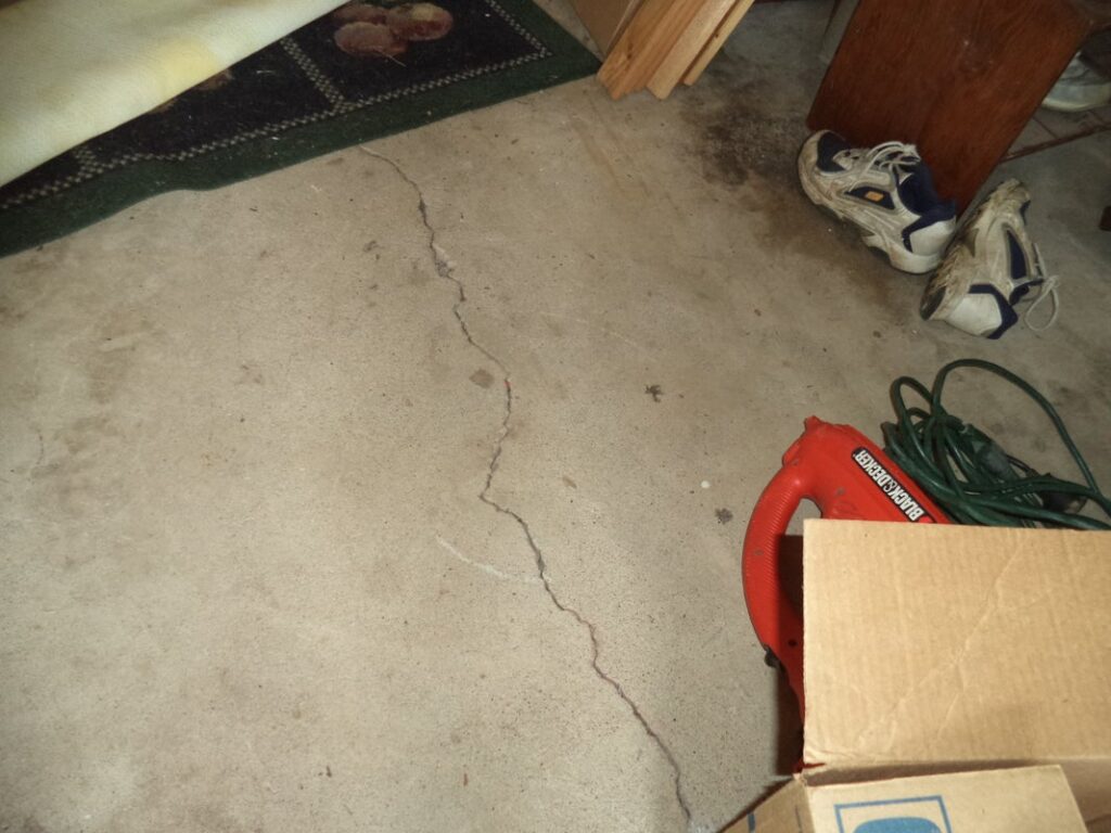 Cracked concrete floor observed during a pre-purchase inspection